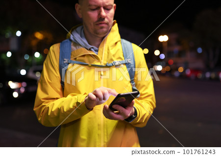 Man uses navigation on smartphone to find way to station Man uses navigation on smartphone to find way to station 101761243
