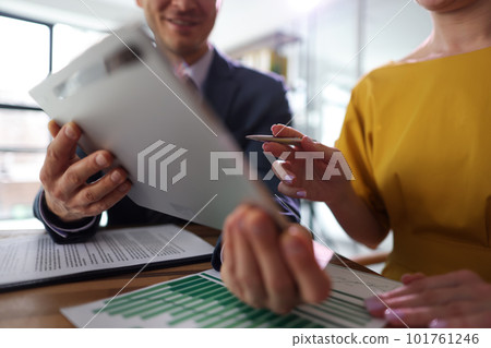 Man in business suit works in office with female client 101761246