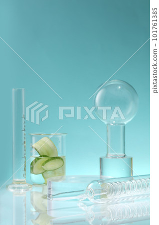 A condenser, volumetric cylinder and a beaker with Cucumber slices inside against a blue background. Cucumber (Cucumis sativus) is a source of moisture and helps the body detox A condenser, volumetric cylinder and a beaker with Cucumber slices inside against a blue background. Cucumber (Cucumis sativus) is a source of moisture and helps the body detox 101761385