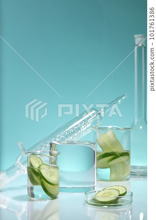A cylinder podium arranged with some laboratory glassware on mirror table. The high water content in Cucumber (Cucumis sativus) is also thought to reduce symptoms of water retention and puffiness 101761386