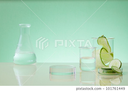 Showcase cosmetics on pedestal modern in laboratory equipment and fresh cucumber slices decorated on pastel background. Cucumber extract is researched and produced natural cosmetics 101761449