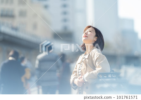 A woman wearing a coat A woman waiting for a meeting A woman with an ennui expression 101761571