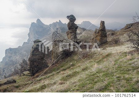 Gingerbread horse rock and bizarre rocks in Dead city. Khoba-Tele Ridge of Karadag Reserve in spring. Crimea Gingerbread horse rock and bizarre rocks in Dead city. Khoba-Tele Ridge of Karadag Reserve in spring. Crimea 101762514