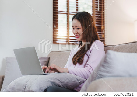 Attractive Asian woman resting comfortable living room and using laptop computer, Relax, Sofa, Lifestyle 101762821