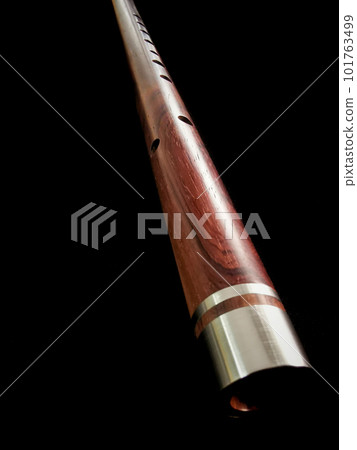 Close up shot of Thai flute. Flute made from siam rosewood with aluminum wrap design Close up shot of Thai flute. Flute made from siam rosewood with aluminum wrap design 101763499