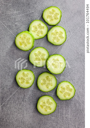 Sliced fresh green cucumber on kitchen table. Top view. 101764494