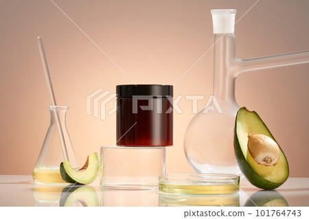 An empty label jar standing on cylinder podium, decorated with glassware containing Avocado (Persea americana) essential oil. helps skin hydrated, reduce oily skin condition and sebum secretion. 101764743