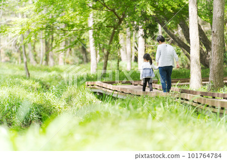 photo of grandchildren and grandma taking a walk 101764784