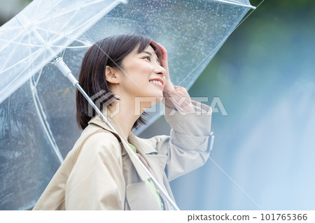 A woman holding an umbrella on a rainy day A woman walking in the rain A woman walking with a smile even in the rain A woman holding an umbrella on a rainy day A woman walking in the rain A woman walking with a smile even in the rain 101765366