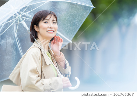 A woman holding an umbrella on a rainy day A woman walking in the rain A woman walking with a smile even in the rain A woman holding an umbrella on a rainy day A woman walking in the rain A woman walking with a smile even in the rain 101765367