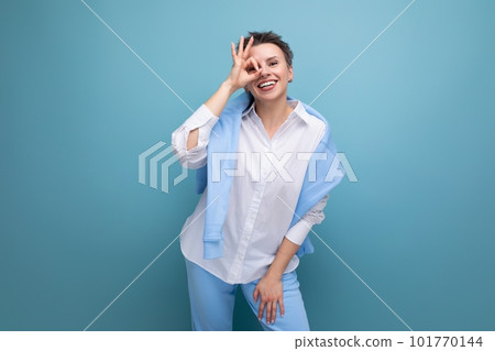 energetic positive young brunette woman with short haircut in white shirt 101770144