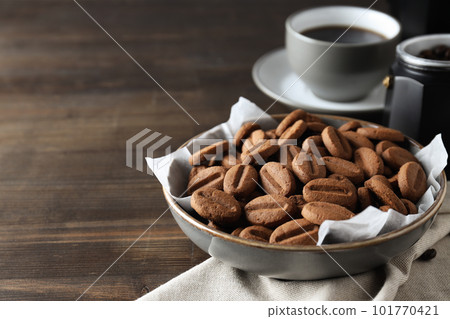 Concept of tasty snack for hot drink - cookies in the shape of coffee seeds 101770421