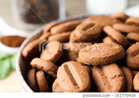 Concept of tasty snack for hot drink - cookies in the shape of coffee seeds 101770426