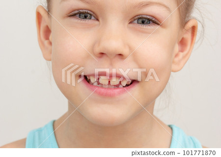 Smiling child face cropped head caucasian little girl of 6 7 years on grey background Smiling child face cropped head caucasian little girl of 6 7 years on grey background 101771870