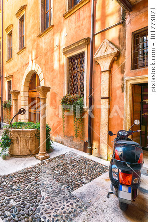 Fantastic narrow street of shops and cafes in the historic medieval old town center of Verona. 101773071