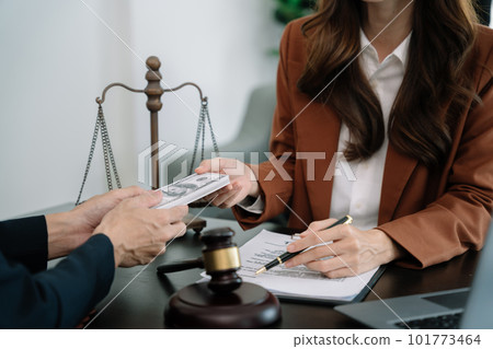 Businessman giving bribe money in the envelope to partner in a corruption scam in office. Businessman giving bribe money in the envelope to partner in a corruption scam in office. 101773464