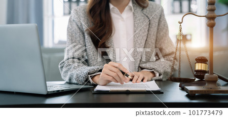 Lawyer signing important legal document on desk at office. Lawyer signing important legal document on desk at office. 101773479