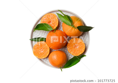 Fresh cutted clementines and whole mandarin over round plate isolated on white background. Food and drink ingredients preparing. healthy eating theme top view with copy space 101773725