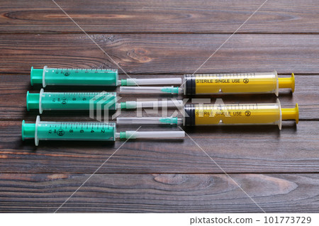 Top view of many syringes prepared for injection at wooden background. Treatment concept with copy space 101773729