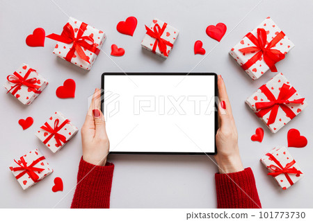 Female hands using a laptop for Valentine day background, gift box and envelope, hearts Female hands using a laptop for Valentine day background, gift box and envelope, hearts 101773730