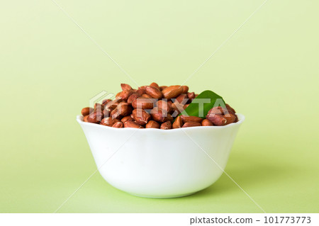Fresh healthy peanuts in bowl on colored table background. Top view Healthy eating bertholletia concept. Super foods Fresh healthy peanuts in bowl on colored table background. Top view Healthy eating bertholletia concept. Super foods 101773773