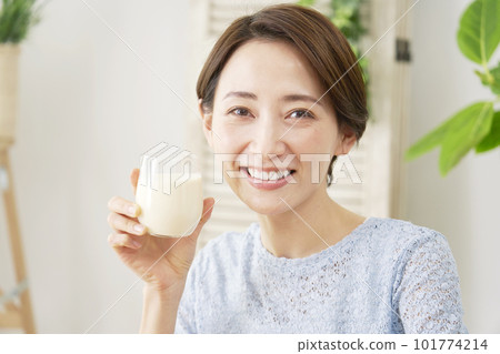 Woman drinking soy milk at home Looking at the camera Looking at the camera Woman drinking soy milk at home Looking at the camera Looking at the camera 101774214