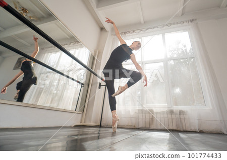 A beautiful Asian woman is dancing at the barre. Ballet dancer. A beautiful Asian woman is dancing at the barre. Ballet dancer. 101774433