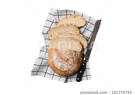 Freshly baked bread cut with knife isolated on white background. top view Sliced bread and knife 101774743