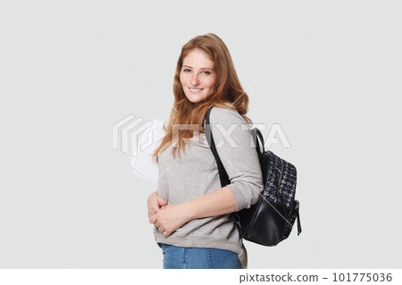 Cute happy woman student standing on white background 101775036