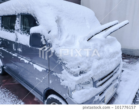 A car with wipers on a snowy day A car with wipers on a snowy day 101776157