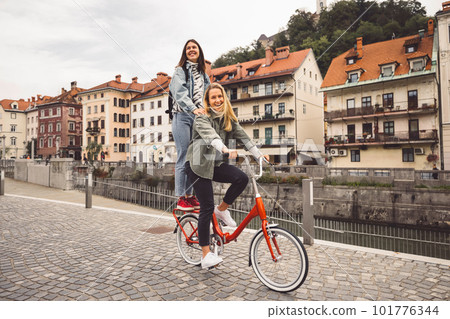 Couple of best friends riding a bike on the Stock Photo