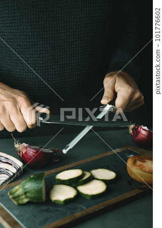 man steeling a kitchen knife man steeling a kitchen knife 101776602