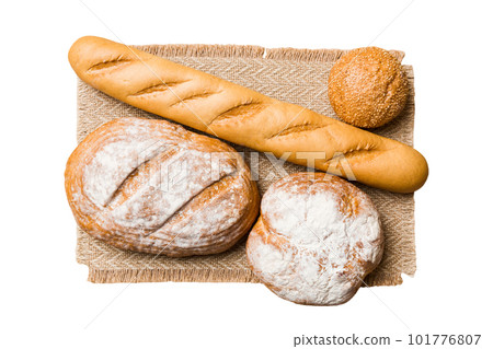 Freshly baked delicious french bread with napkin isolated on white background top view. Healthy white bread loaf 101776807