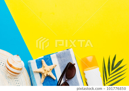 Beach accessories straw hat and seashell on colored table. Summer concept background 101776850