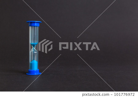 hourglass on the table, sand clock as time passing concept for business deadline, copy space hourglass on the table, sand clock as time passing concept for business deadline, copy space 101776972