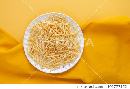 potato straw on yellow background potato straw on yellow background 101777152