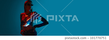Banner with one stylish woman wearing black sunglasses with digital neon filter lights on clothes over blue background. Copy space for ad, text Banner with one stylish woman wearing black sunglasses with digital neon filter lights on clothes over blue background. Copy space for ad, text 101778751