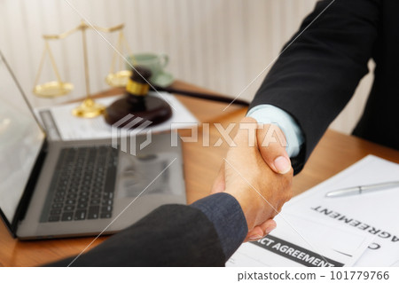The lawyer shook hands with the client after completing the consultation in the case. The lawyer shook hands with the client after completing the consultation in the case. 101779766