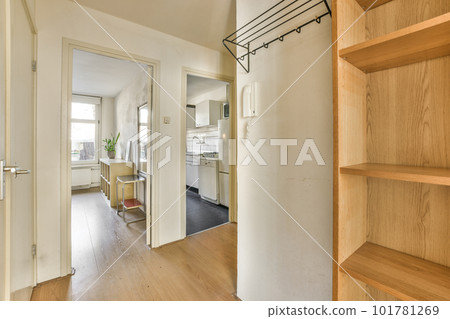 a kitchen and dining area in a house with wood floors, white walls, and open shelvings on the wall a kitchen and dining area in a house with wood floors, white walls, and open shelvings on the wall 101781269