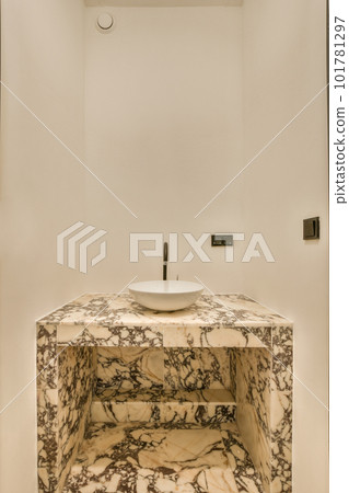 a marble sink in a white bathroom with black trim around the edge and an oval mirror on the wall above it a marble sink in a white bathroom with black trim around the edge and an oval mirror on the wall above it 101781297