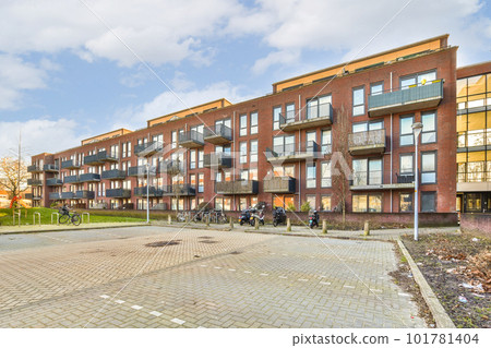 a bricked area in the middle of an apartment complex with bikes parked on the sidewalk and people walking around a bricked area in the middle of an apartment complex with bikes parked on the sidewalk and people walking around 101781404