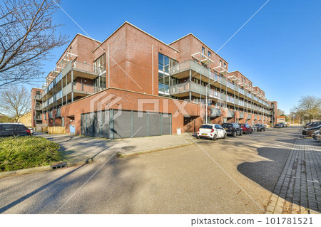 an apartment building with cars parked in the parking lot next to it on a clear blue sky day or sunny day an apartment building with cars parked in the parking lot next to it on a clear blue sky day or sunny day 101781521