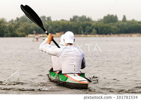 rear view two male kayakers on kayak double in kayaking competition race, sports summer games rear view two male kayakers on kayak double in kayaking competition race, sports summer games 101781534