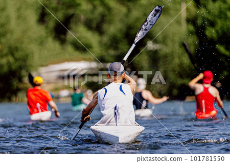 rear view group athletes kayakers on kayak single rowing on lake, summer outdoors sports 101781550