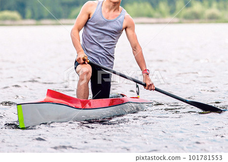 front view male athlete canoeist on canoe single, after finish line, paddle the water, summer outdoors sports 101781553