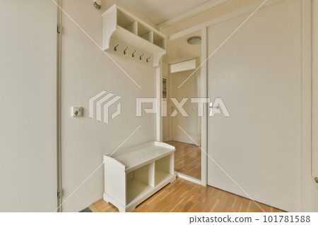 an empty room with white walls and wood flooring on the right side of the room, there is a door to another room an empty room with white walls and wood flooring on the right side of the room, there is a door to another room 101781588