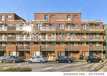 an apartment complex with cars parked in the parking lot and sun shining on the building's balkrooms 101781608