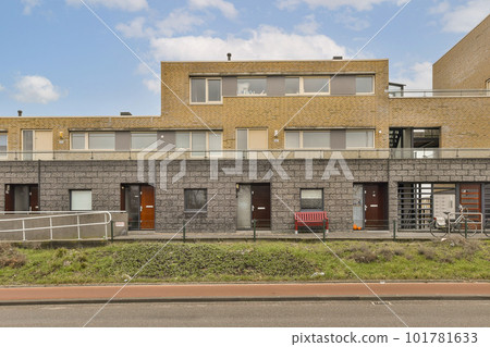 an empty building with no people on the street in front of it and there is only one person standing outside an empty building with no people on the street in front of it and there is only one person standing outside 101781633