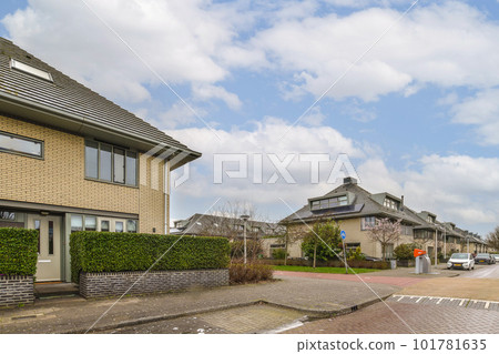 an empty street with houses in the background and clouds in the blue sky above, as seen from the ground an empty street with houses in the background and clouds in the blue sky above, as seen from the ground 101781635