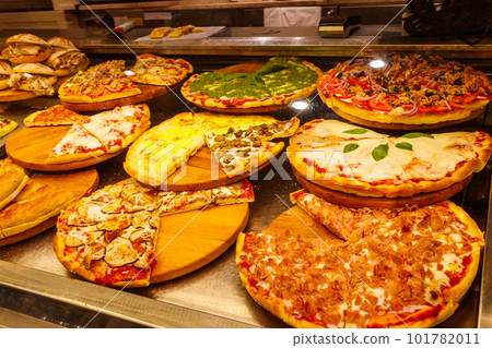 Assortment of italian pizza in the showcase of pizzeria Assortment of italian pizza in the showcase of pizzeria 101782011